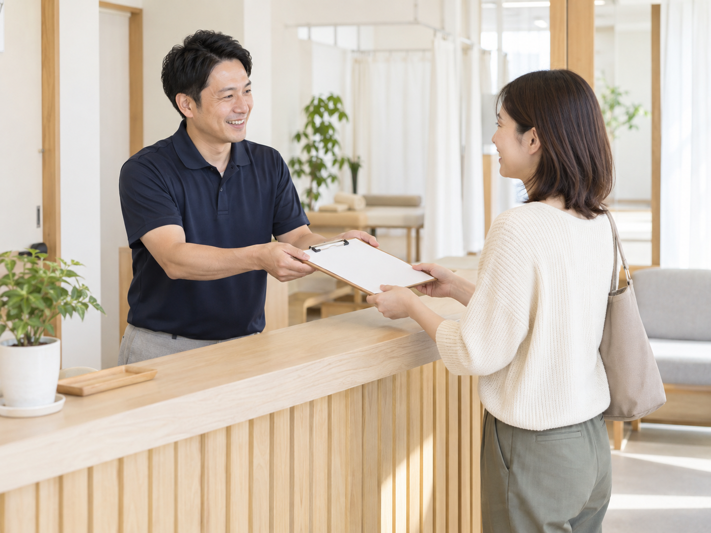 受付カウンターで来院者に問診票を渡す場面（AI生成のイメージ）